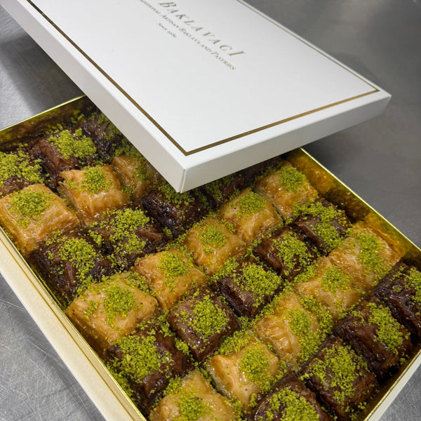 Box of baklava with green pistachio on a metallic surface